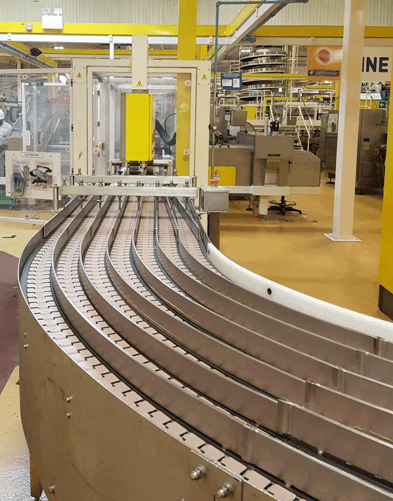 Curved conveyor in manufacturing facility