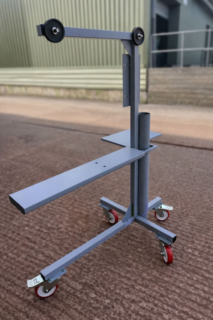 Finished mobile press stand for conveyor belt processing, designed by Barair with counterbalance support arm, welded steel frame and lockable castors.